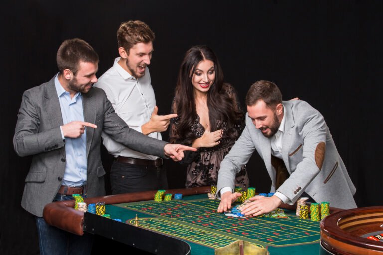 Group of young people behind roulette table